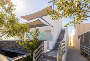 a staircase leading up to a house with trees at Ageri Suite II in Vóthon