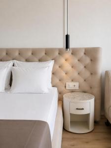 a bedroom with a large bed with a white bedspread at Hotel Jupiter in Sunny Beach