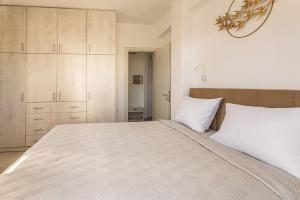 a white bedroom with a large bed with white pillows at Ageri Suite II in Vóthon
