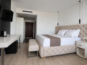 a bedroom with a large bed and a desk at Hotel Jupiter in Sunny Beach