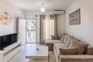 a living room with a couch and a tv at Ageri Suite II in Vóthon