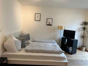 a bedroom with a bed and a television in it at INN Apart Tirol in Innsbruck