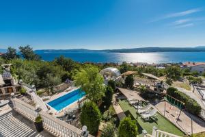 an apartment with a swimming pool and a view of the water at Villa Mara in Crikvenica