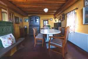 a dining room with a table and chairs at Home in Heaven I Historical Log House in Šentrupert