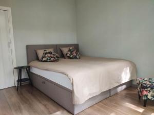 a bed with two pillows on it in a room at Luxe chalet midden in de natuur in Rijen +12 photos