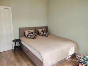 a bed with two pillows on it in a room at Luxe chalet midden in de natuur in Rijen