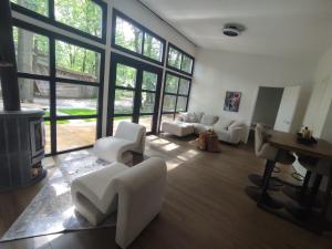 a living room with white furniture and a fireplace at Luxe chalet midden in de natuur in Rijen