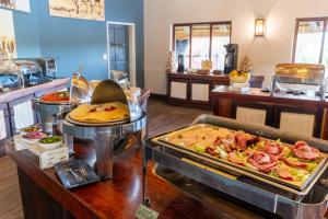 a buffet line with many different types of food at Gondwana Hakusembe River Lodge in Rundu +19 photos