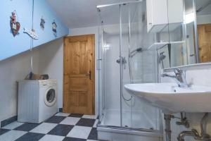 a bathroom with a sink and a washing machine at Home in Heaven I Historical Log House in Šentrupert