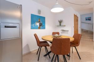 a dining room with a wooden table and chairs at Private Detached House-2 Bedroom&3 Bathroom with Relaxing Garden Terrace-Grubelic House in Rab