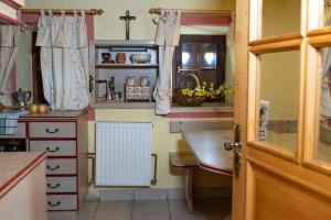a kitchen with a sink and a table in it at Home in Heaven I Historical Log House in Šentrupert