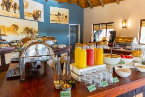 a kitchen with a counter with a bunch of drinks at Gondwana Hakusembe River Lodge in Rundu