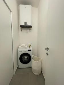 a small laundry room with a washing machine in it at Moon Apartments A in Soverato Marina