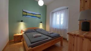 a bedroom with a bed with two pillows on it at Das Eckhaus in Murau