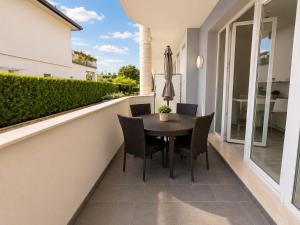 a patio with a table and chairs on a balcony at Borgo degli Ulivi Residence in Toscolano Maderno