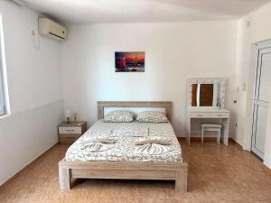 a bedroom with a bed and a table and a mirror at Eki 2026 VIP in Donji Štoj +30 photos