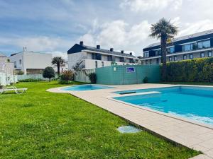 a swimming pool in a yard next to a building at Cavado Pool Apartment in Fão