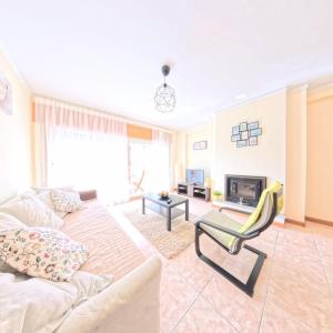 a living room with a couch and a fireplace at Cavado Pool Apartment in Fão