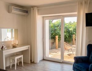 a living room with a sliding door to a deck at AGATA BEACH Boutique -Adult Only in Ahtopol