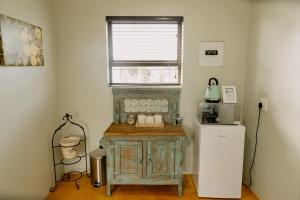 a kitchen with a wooden cabinet and a refrigerator at Benedicto Farm in Welkom
