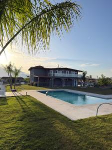 a house with a swimming pool in front of a house at Rooms Vesuvio Est in Striano