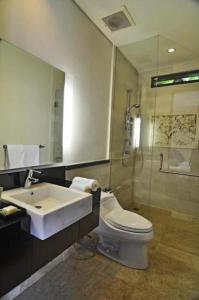 a bathroom with a sink and a toilet and a shower at Villa Kejora 10 in Sanur +16 photos