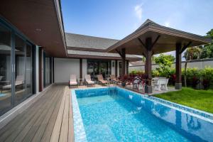 a swimming pool in the backyard of a house at summer stay pool villa in Ban Na Bon