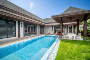 a swimming pool in the backyard of a house at summer stay pool villa in Ban Na Bon
