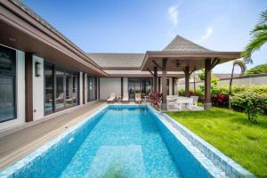 an image of a swimming pool in the backyard of a house at summer stay pool villa in Ban Na Bon +4 photos
