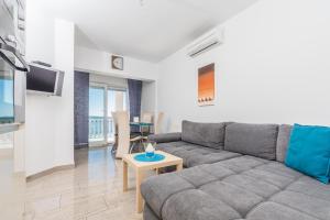 a living room with a couch and a table at Villa Mara in Crikvenica