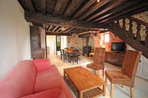 a living room with a couch and chairs and a table at Les bonnes fontaines in Cieux
