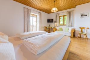 a bedroom with two beds and a living room at Weingut Peter Skoff - Domäne Kranachberg in Gamlitz