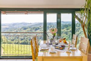 a dining room table with a view of the mountains at Weingut Peter Skoff - Domäne Kranachberg in Gamlitz