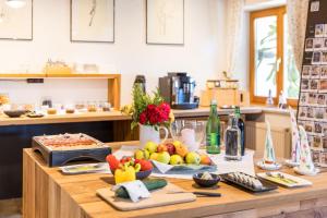 a table with fruits and vegetables on it in a kitchen at Weingut Peter Skoff - Domäne Kranachberg in Gamlitz +11 photos