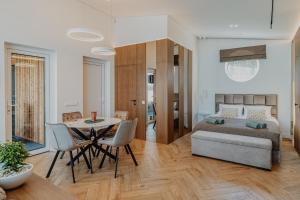 a bedroom with a bed and a table and chairs at Lavyso perlai, 3-4 nameliai in lavysas +23 photos