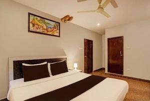 a bedroom with a large bed and a ceiling fan at Hotel Vaishnavi in Hyderabad +18 photos