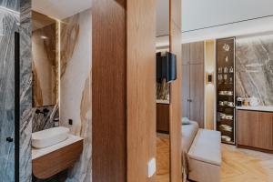 a bathroom with a sink and a toilet and a mirror at Lavyso perlai, 3-4 nameliai in lavysas