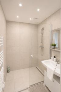 a bathroom with a shower and a sink at Danube Suites in Vienna +26 photos