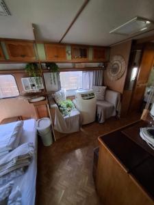an rv with a kitchen and a living room at Côté plage in Vias