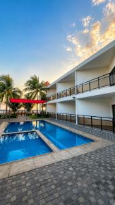 a swimming pool in front of a building at Hotel Portofino in Canoguero