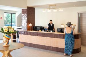 a woman standing at the counter of a restaurant at Modica Inn Centro, BW Premier Collection in Modica +73 photos