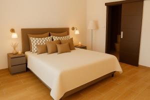 a bedroom with a large white bed with brown pillows at Casa ZOMABRIA in Poreč +18 photos