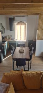 a living room with a wooden table and chairs at Duplex Le Trèfle in Charmes-sur-lʼHerbasse
