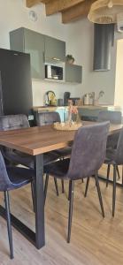 a dining room table with chairs in a kitchen at Duplex Le Trèfle in Charmes-sur-lʼHerbasse