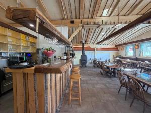 a bar in a restaurant with tables and chairs at Gut Sonnenhof in Žatec