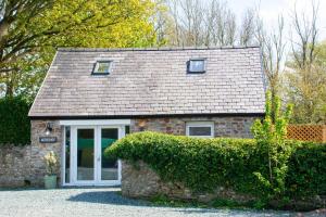 a small brick house with a roof at Cosy Hideaway I Couples Break I Private Estate in Newborough