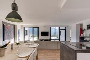 a kitchen and living room with a table and a couch at Villa Bamboo in Lathuile