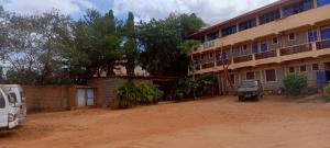 a building with a truck parked in front of it at Charonyi Safari Lodge in Gutini