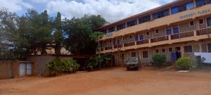 a building with a truck parked in front of it at Charonyi Safari Lodge in Gutini