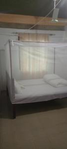 a bunk bed with white sheets in a room at Charonyi Safari Lodge in Gutini